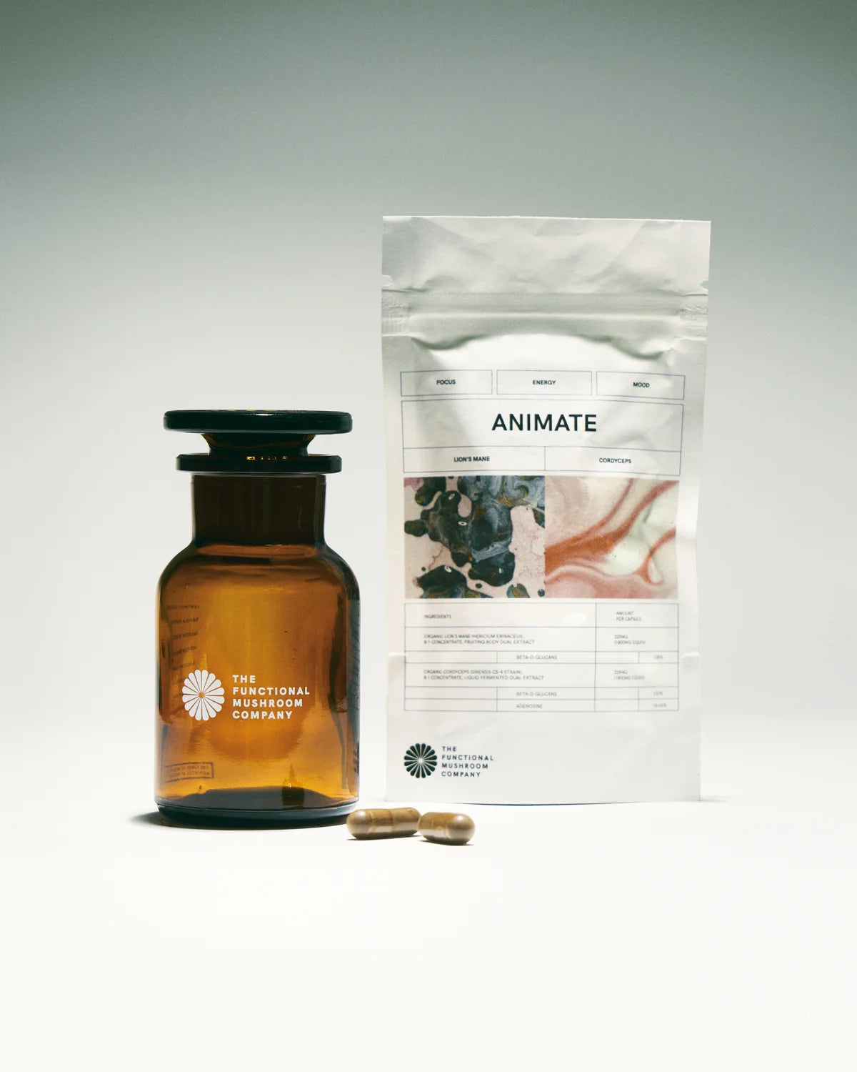 Amber glass bottle with a white label, two capsules, and a white packaging sleeve labeled 'Animate' on a light gray background.