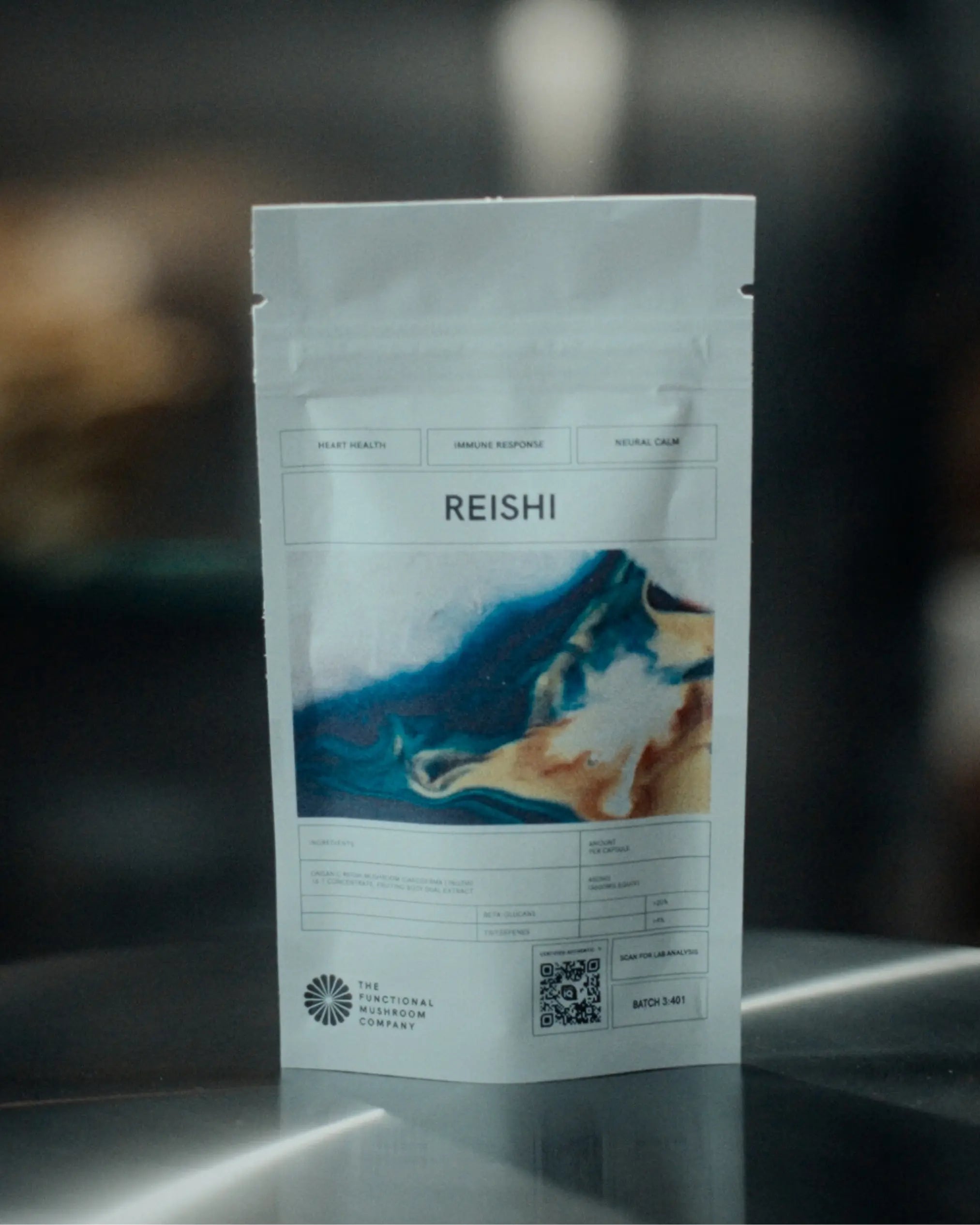 Reishi mushroom packaging on a reflective surface with a blurred background