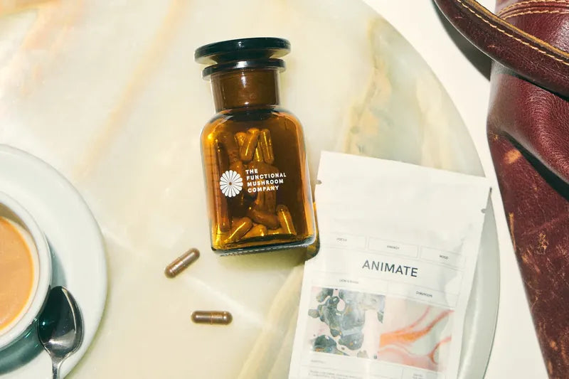 The Animate jar, a capsule, an espresso and a sachet on an onyx tray.